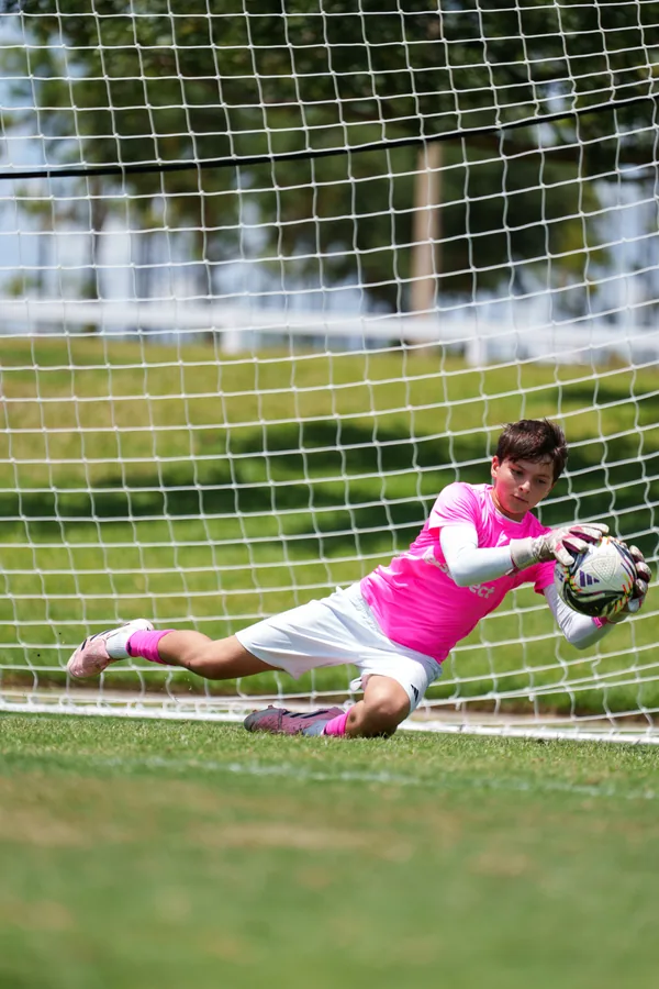 Gavin diving with the ball held in his gloves